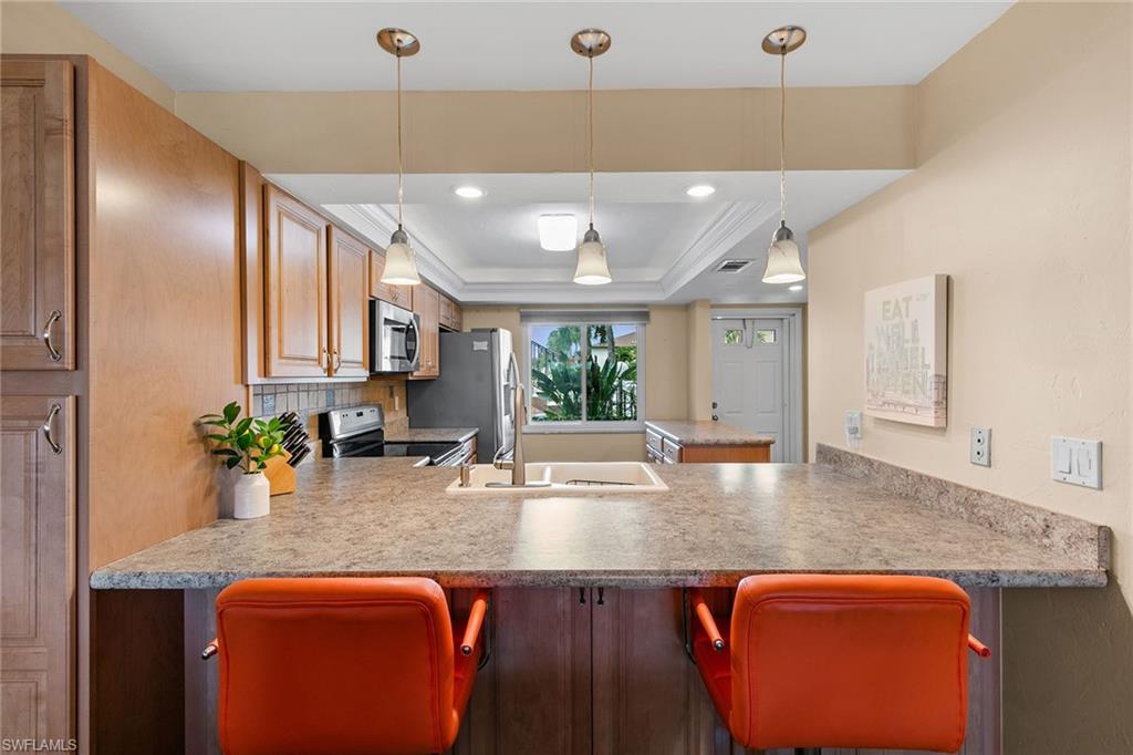 a kitchen with stainless steel appliances granite countertop sink stove top oven and cabinets