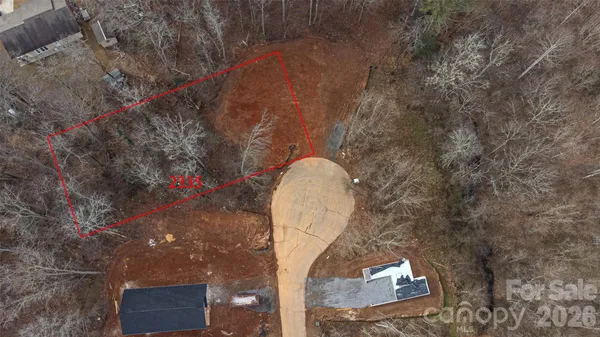 a aerial view of a house with a yard and wooden fence