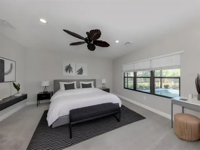 a bedroom with a large bed and a large window