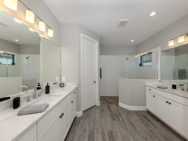 a bathroom with a double vanity sink and mirror