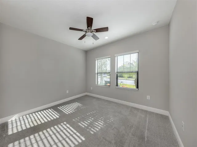 a view of a big room with wooden floor closet and windows