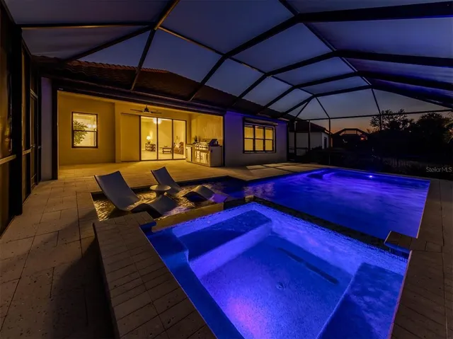 a view of swimming pool with red umbrella