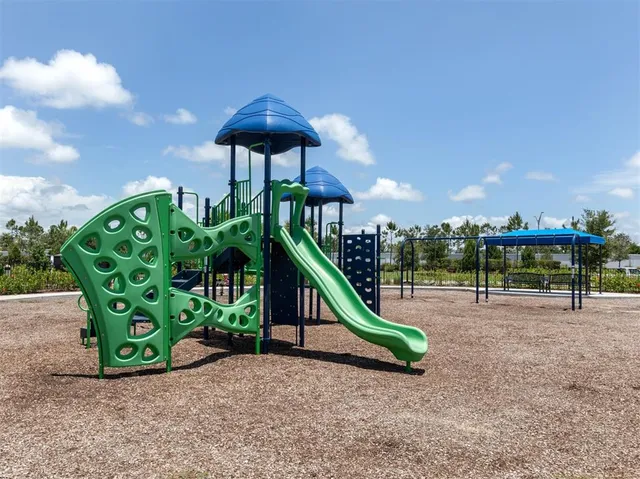 a view of a park with swings and slides