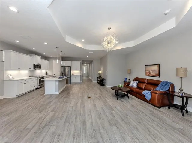 a living room with furniture and kitchen view