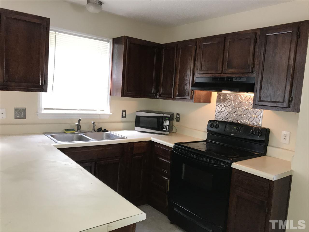 1728 Vintage Road Raleigh, NC 27610 - Photo 6 of 16 a kitchen with sink cabinets and appliances