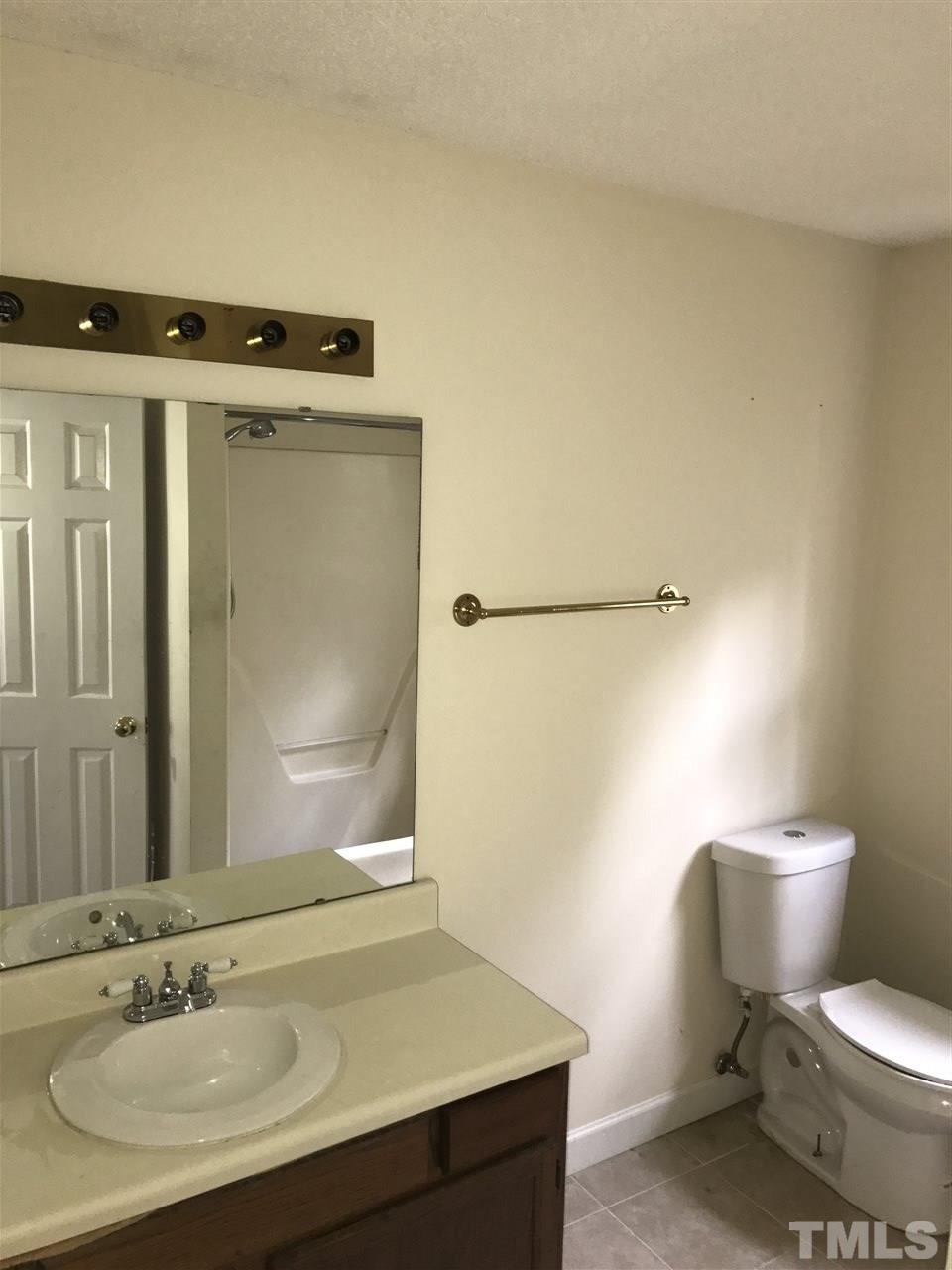 1728 Vintage Road Raleigh, NC 27610 - Photo 8 of 16 a bathroom with a sink toilet and shower