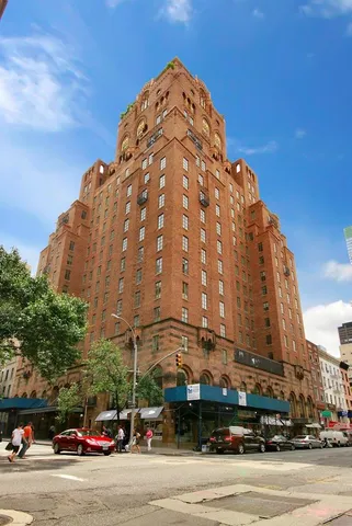 a view of a tall building next to a road