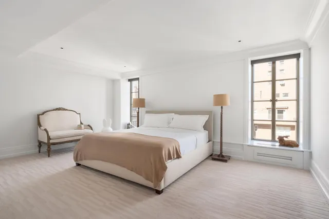 a spacious bedroom with a bed and a window