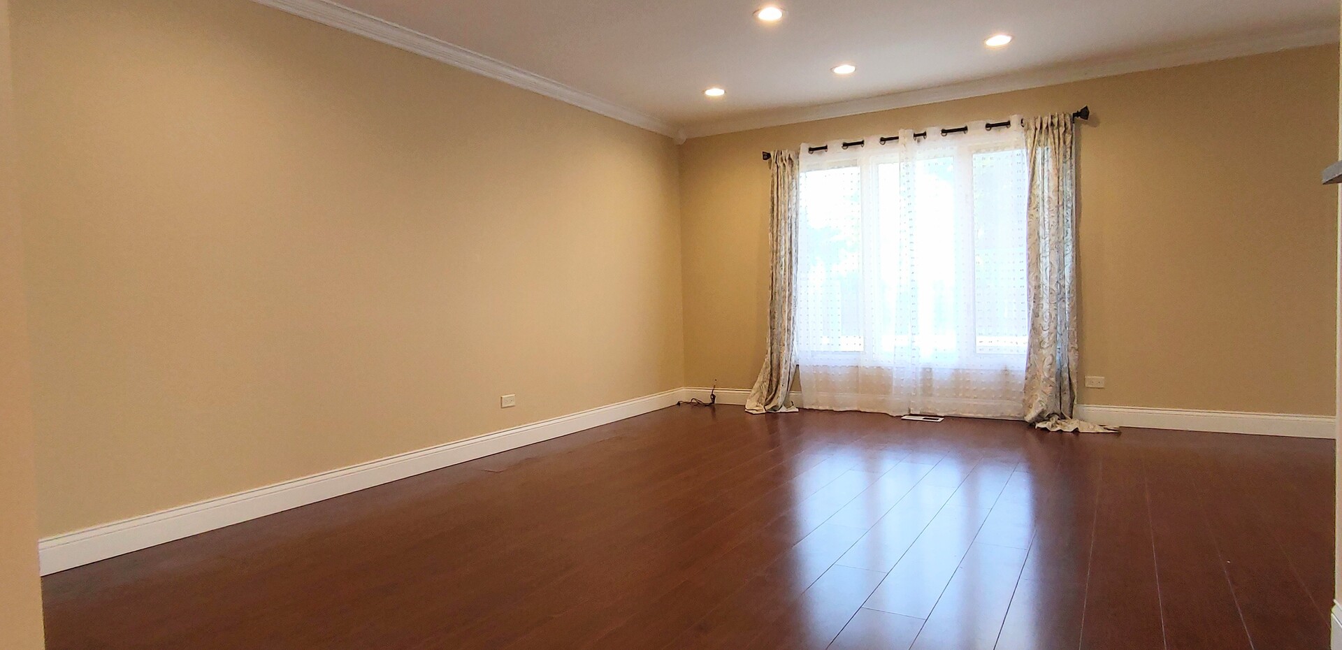 1160 Hassell Road Hoffman Estates, IL 60169 - Photo 4 of 24 an empty room with wooden floor and a window
