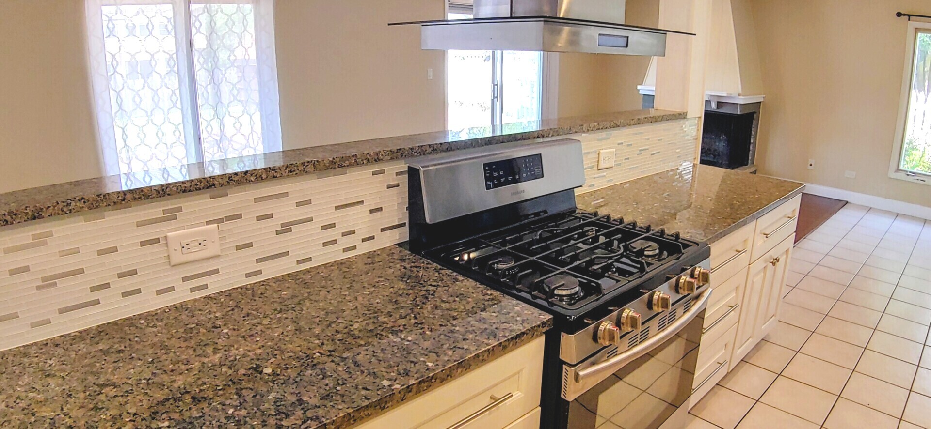 1160 Hassell Road Hoffman Estates, IL 60169 - Photo 9 of 24 a kitchen with granite countertop a stove a sink and white cabinets