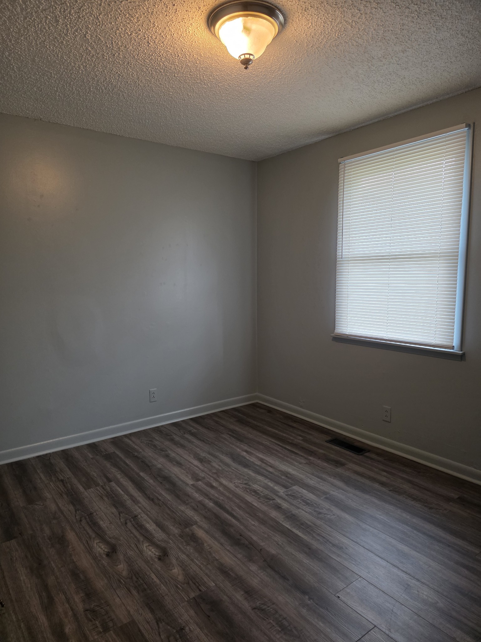 226 Becklea Drive Madison, TN 37115 - Photo 11 of 20 an empty room with wooden floor and windows