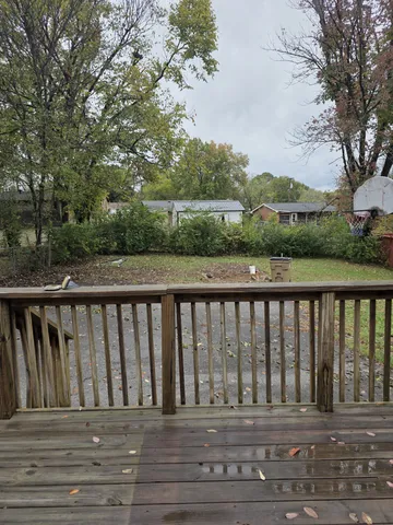 a balcony with wooden floor and fence