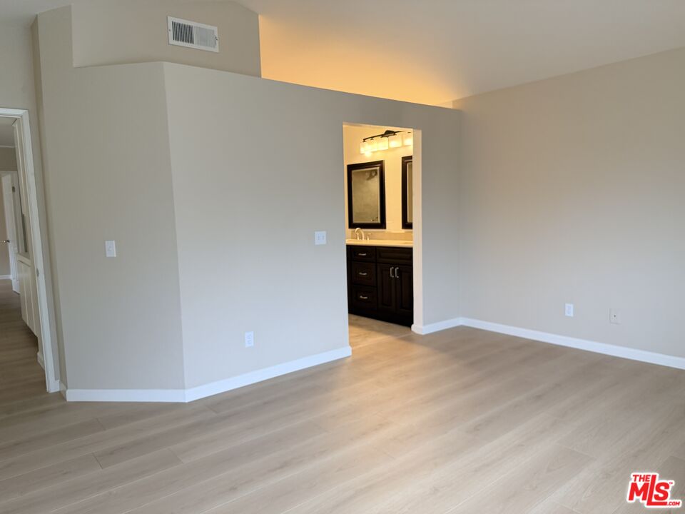 13099 Reindeer Court Riverside, CA 92503 - Photo 12 of 24 a view of an empty room with wooden floor and a window