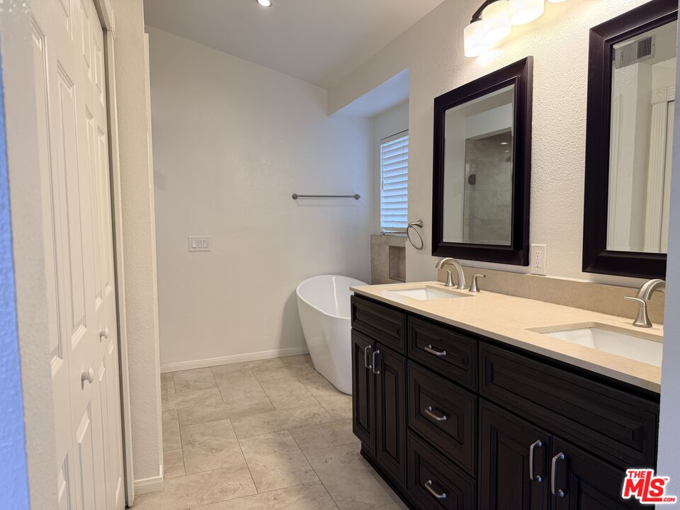 13099 Reindeer Court Riverside, CA 92503 - Photo 13 of 24 a bathroom with a double vanity sink and mirror