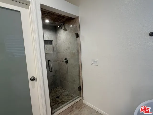 a bathroom with a glass shower door