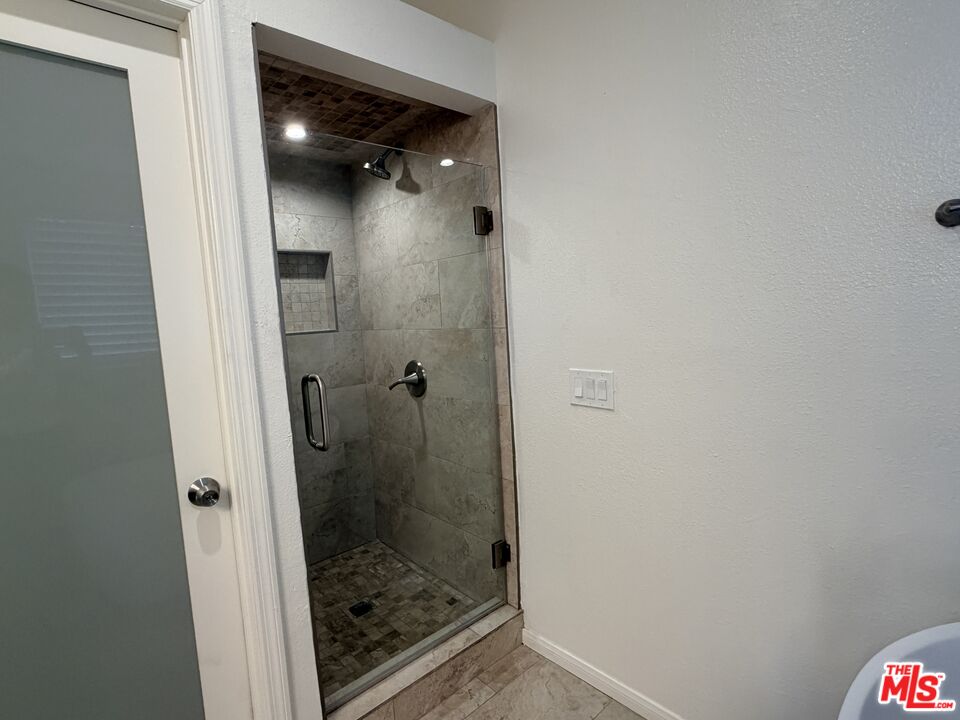 13099 Reindeer Court Riverside, CA 92503 - Photo 14 of 24 a bathroom with a glass shower door