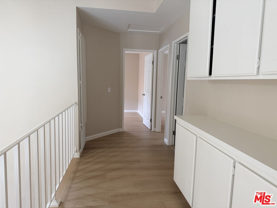13099 Reindeer Court Riverside, CA 92503 - Photo 16 of 24 a view of a hallway with wooden floor
