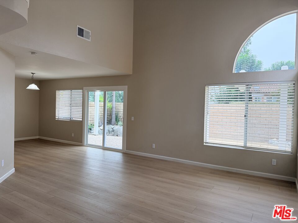 13099 Reindeer Court Riverside, CA 92503 - Photo 2 of 24 a view of an empty room with wooden floor and a window