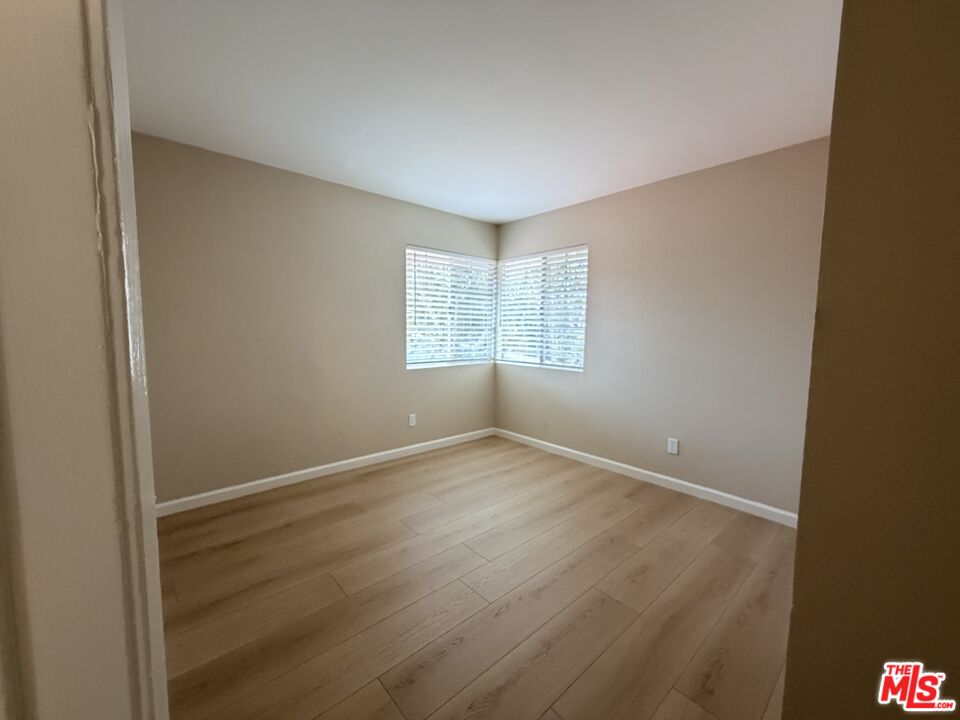 13099 Reindeer Court Riverside, CA 92503 - Photo 21 of 24 an empty room with wooden floor and windows