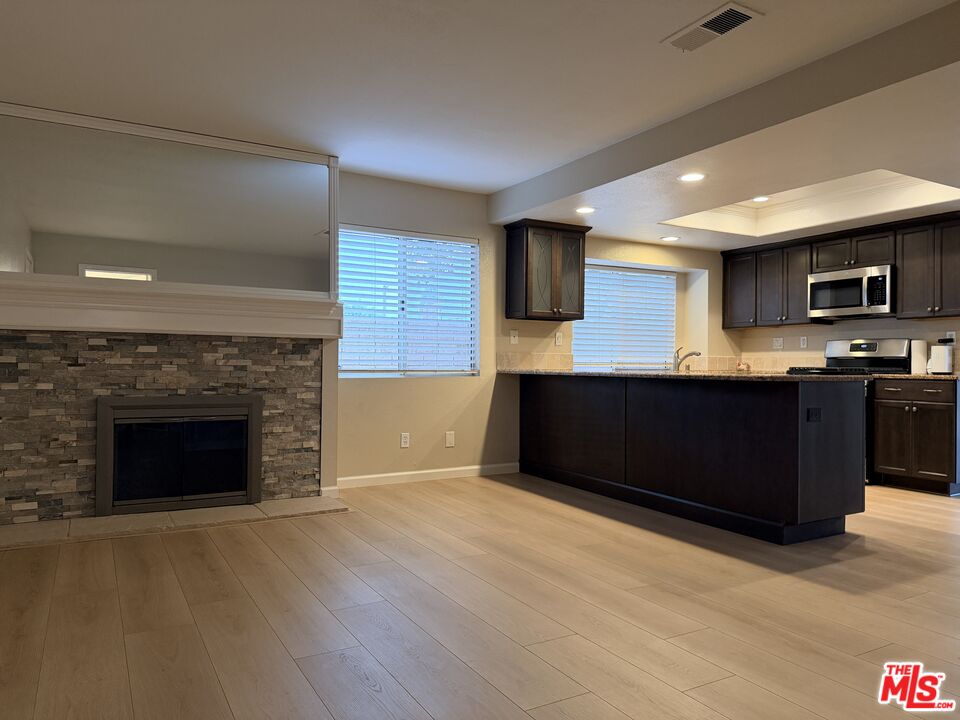 13099 Reindeer Court Riverside, CA 92503 - Photo 9 of 24 a kitchen with kitchen island a sink dishwasher a stove and a refrigerator