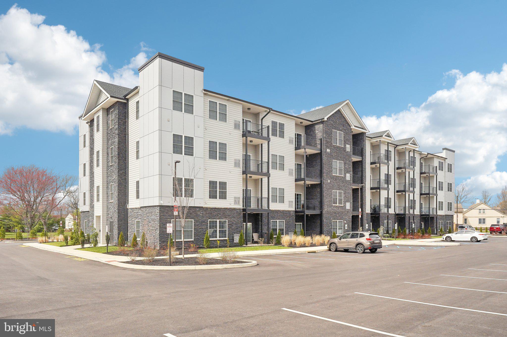 2421 Bristol Road, Unit 206 Warrington, PA 18976 - Photo 2 of 18 a city street with tall buildings in the background