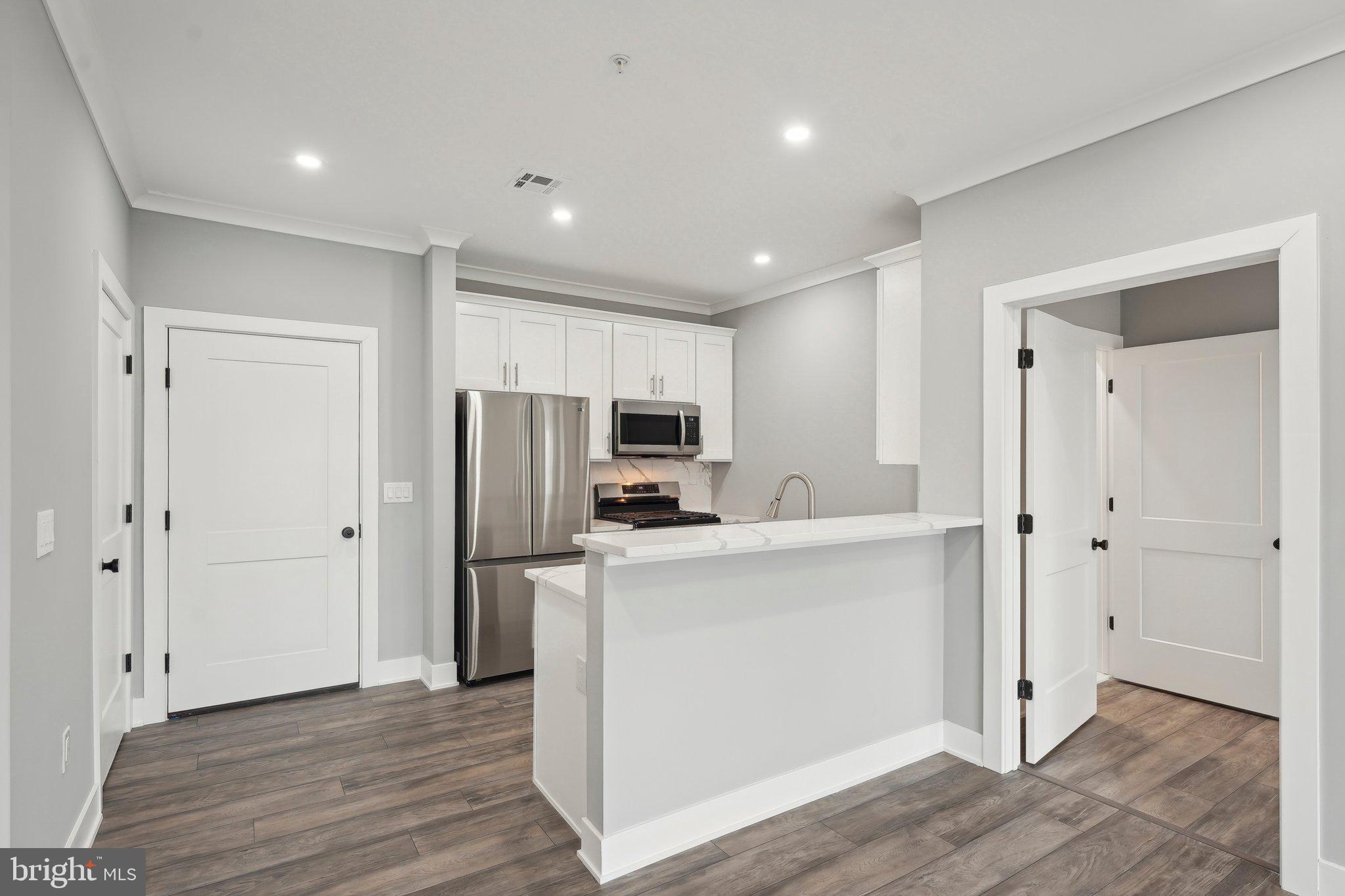 2421 Bristol Road, Unit 206 Warrington, PA 18976 - Photo 5 of 18 a view of kitchen with stainless steel appliances refrigerator oven and microwave