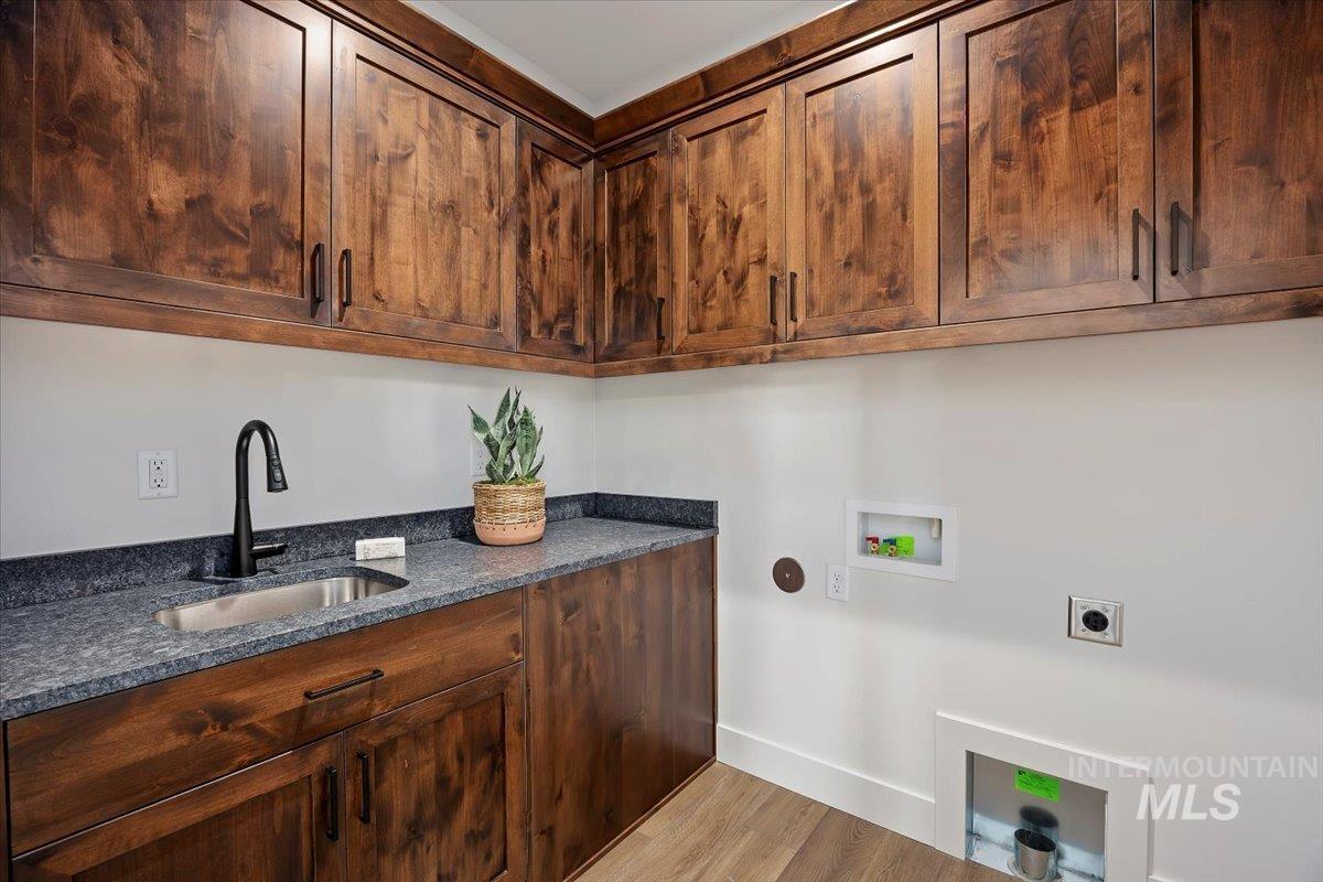 258 Maxine Lane, Unit HOMESITE 207 Kimberly, ID 83341 - Photo 15 of 19 Laundry area featuring hookup for a washing machine, light wood-style flooring, cabinet space, and hookup for an electric dryer