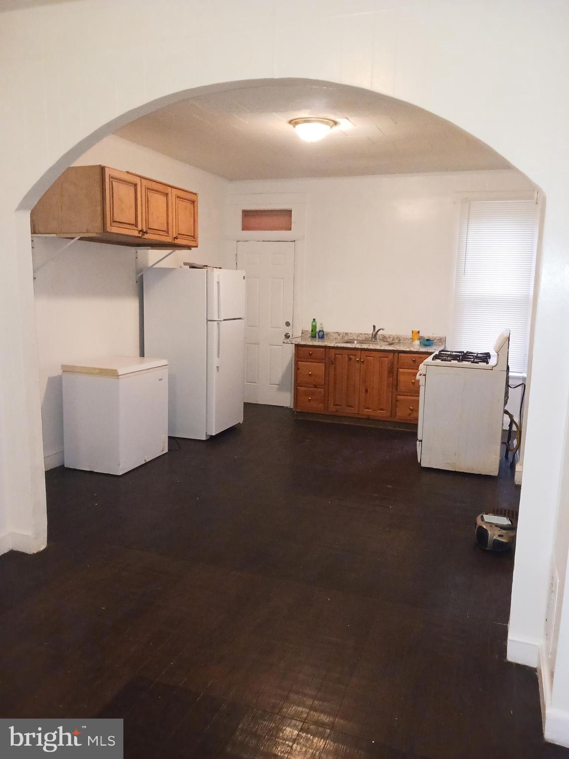 1708 Normal Avenue Baltimore, MD 21213 - Photo 6 of 14 a living room with furniture and a chandelier