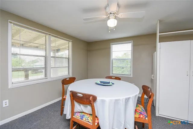 a dining room with furniture and window