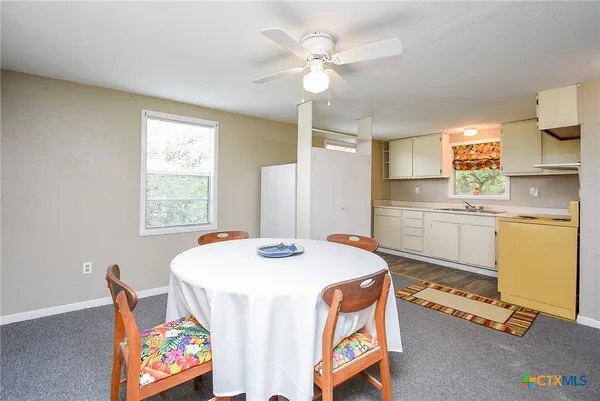 a dining room with furniture a window and appliances