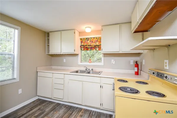 a utility room with cabinets washer and dryer