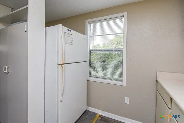 a refrigerator freezer sitting inside of a kitchen