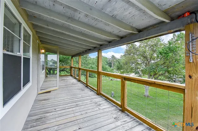 a view of a balcony with wooden floor