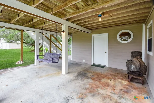 a view of a porch with a table and a chair
