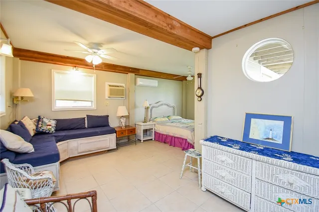 a bedroom with furniture and a window