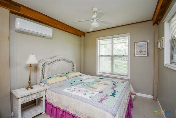 a bedroom with a bed and a window