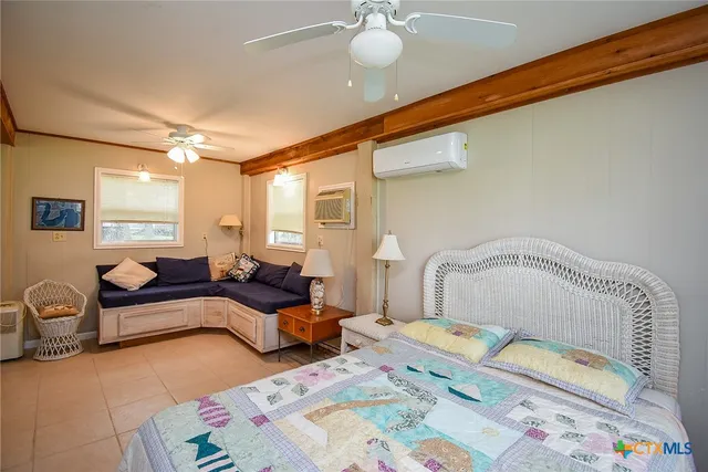 a bedroom with furniture and a large window