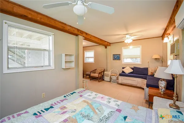 a bedroom with furniture and a lamp