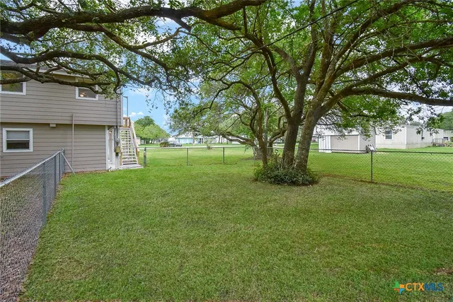 a view of a house with a backyard