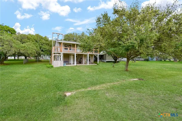 a view of an house with backyard space and garden