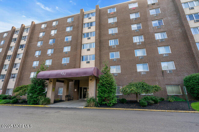 a view of a brick building next to a yard