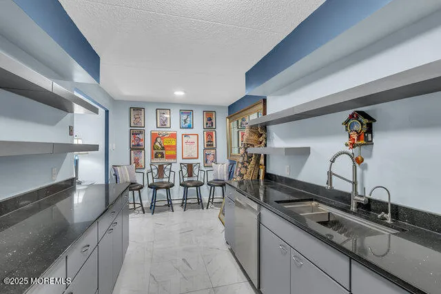 a kitchen view with wooden floor and stainless steel appliances