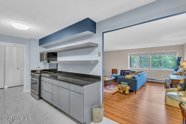 860 Lower Ferry Road, Unit 1K Ewing, NJ 08628 - Photo 15 of 49 a kitchen view with wooden floor and stainless steel appliances