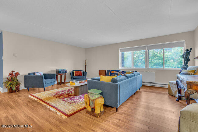 860 Lower Ferry Road, Unit 1K Ewing, NJ 08628 - Photo 22 of 49 a living room with furniture and a wooden floor