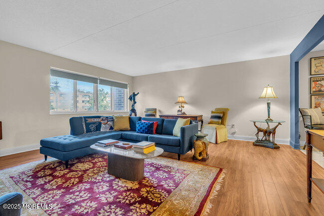 860 Lower Ferry Road, Unit 1K Ewing, NJ 08628 - Photo 24 of 49 a living room with furniture and a wooden floor