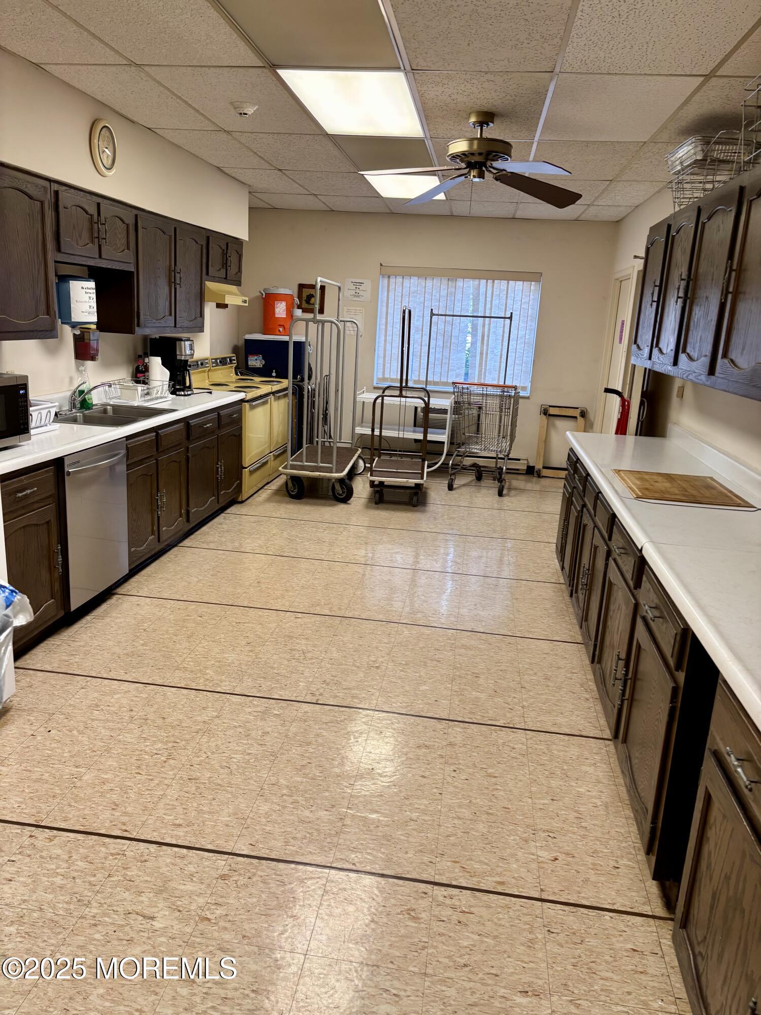 860 Lower Ferry Road, Unit 1K Ewing, NJ 08628 - Photo 41 of 49 a kitchen with stainless steel appliances kitchen island granite countertop a stove a sink and a refrigerator