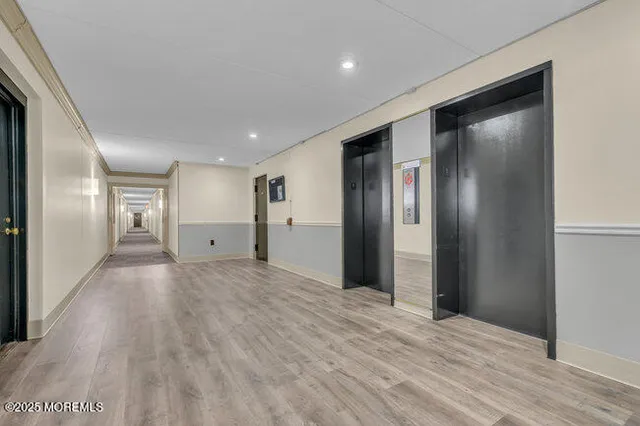 a view of hallway with wooden floor