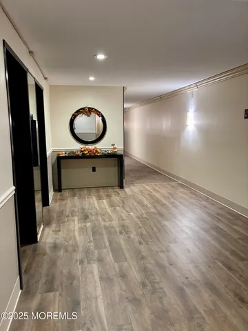 a room with a mirror and a wooden floor