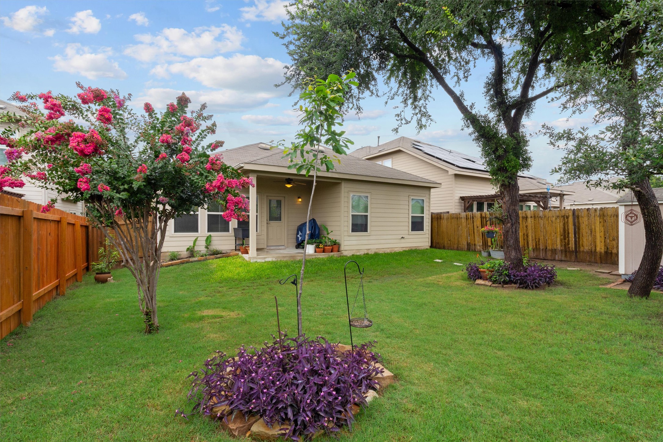 10413 Crescendo Lane Austin, TX 78747 - Photo 24 of 32 A private, fenced backyard oasis with mature trees and a comfortable covered patio awaits.