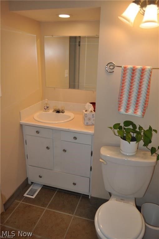 11805 Granger Road Cleveland, OH 44125 - Photo 9 of 9 Bathroom with vanity, tile floors, and toilet